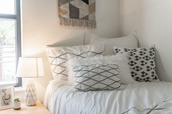 Bed decorated with throw pillows