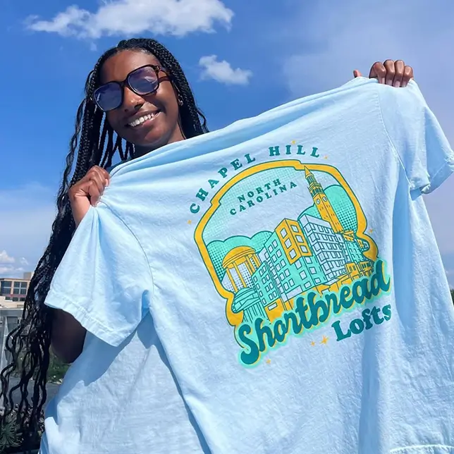 young woman holding a t-shirt